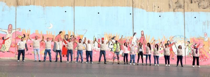 بنك الإسكان يشارك في رسم جدارية للتوعية بمرض سرطان الثدي